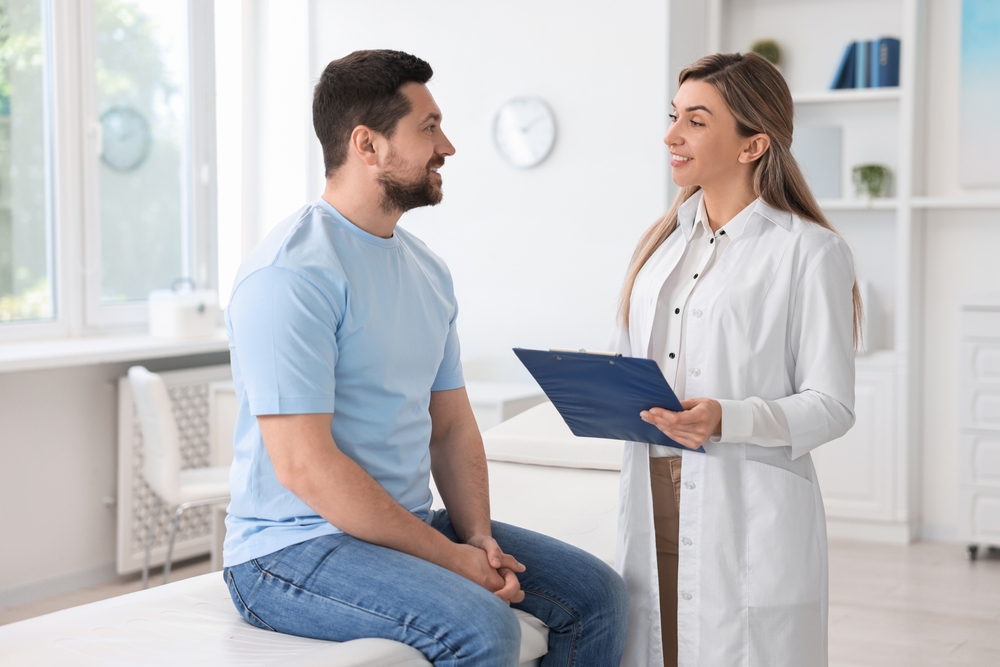 Physician speaking with a man about insurance benefits for shockwave therapy in LA